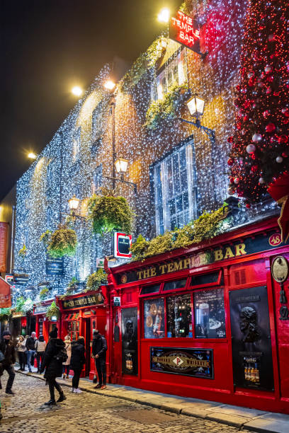 Dublin, Ireland - The Temple Bar Pub at Christmas The Temple Bar Pub in Temple Lane decorated for Christmas. It is located in the Temple Bar quarter in Dublin, the capital city of Ireland. People. temple bar pub stock pictures, royalty-free photos & images