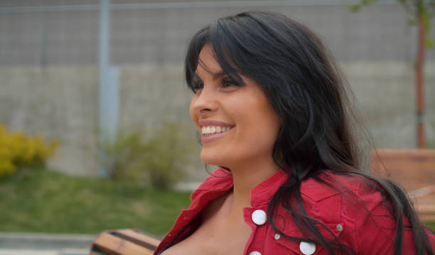istock Smiling woman sitting on the bench 1224759339