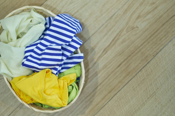istock Top view Clothes in a laundry basket on Wood floor 1224760324
