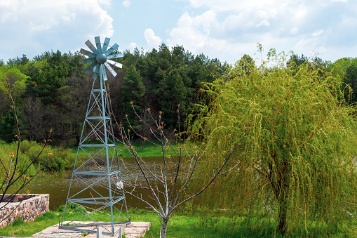 Aeration pumps and windmills. Sunlit windmill close-up