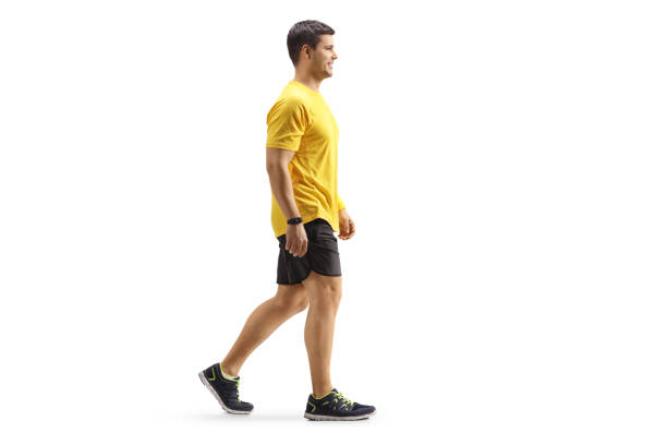 Full length profile shot of a man in sportswear walking Full length profile shot of a man in sportswear walking isolated on white background athleticism photos stock pictures, royalty-free photos & images