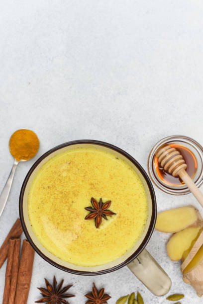 istock Golden milk in cup with star anise and ingredients around. 1224763324