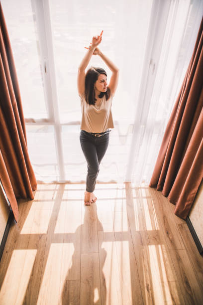 istock young woman posing near window at home 1224766854