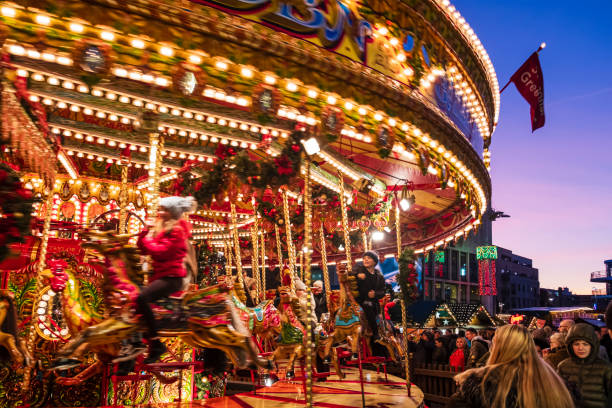 Children enjoy the ride on a carousel at the Christmas Market set up in Millennium Square in downtown Leeds.