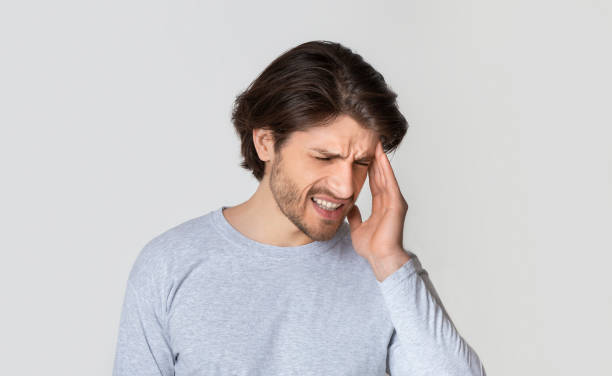 istock Young beautiful man suffering from headache or migraine 1224768681