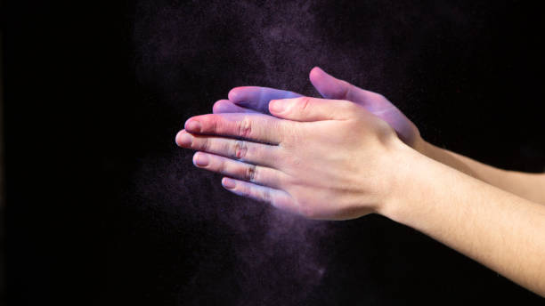 istock Purple paint and hands on black background 1224769827