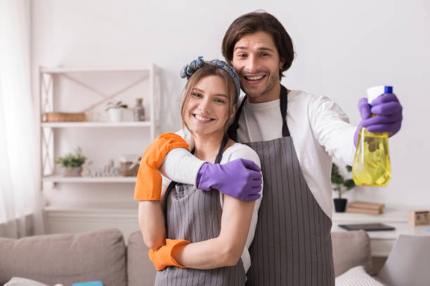 istock Romantic Couple Tidying Flat Together, Hugging And Posing To Camera 1224770916