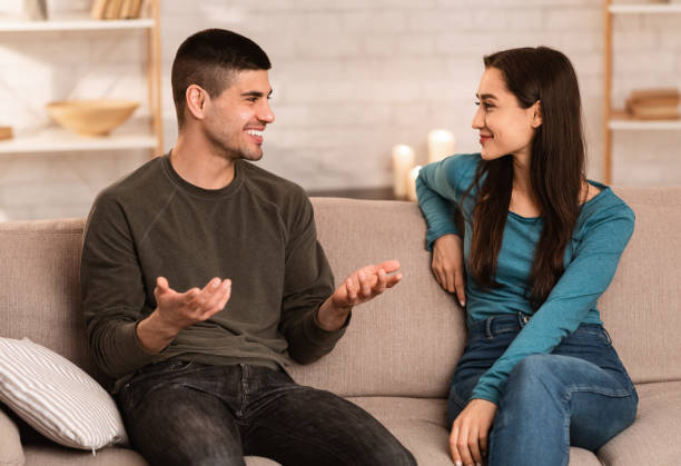 istock Lovely couple sitting on couch spending time together 1224771355