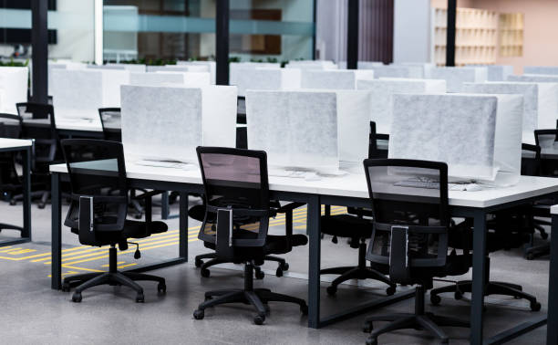 istock Photo of a computers wrapped in cover, empty coworking 1224771378