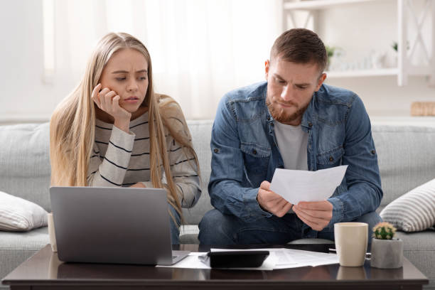 istock Unhappy couple reading bank notification, calculating budget 1224771652