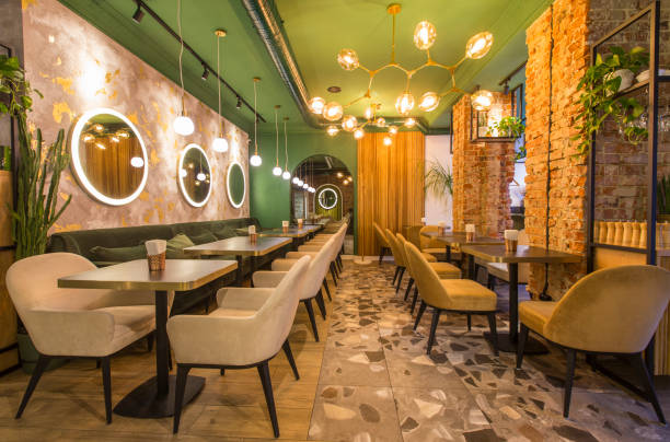 istock Modern restaurant interior with tables and sofas, light green walls 1224772621