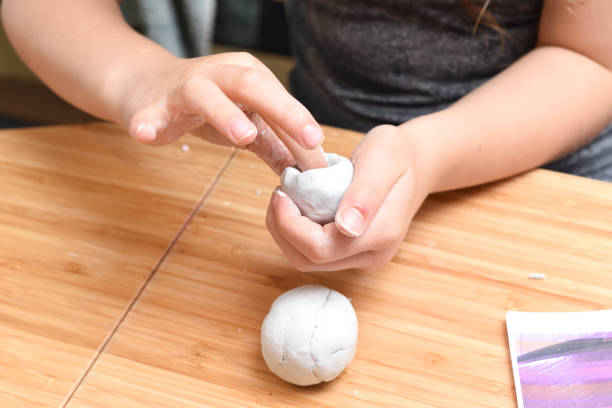 istock Girl making pottery models with white clay at home 1224772697