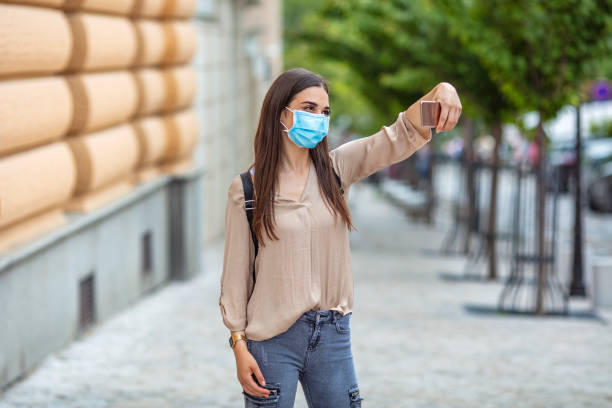 istock Girl taking selfie on phone on empty street. 1224772733