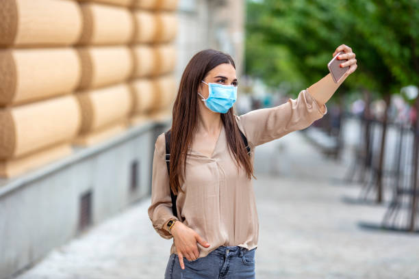 istock Girl taking selfie on phone on empty street. 1224772765