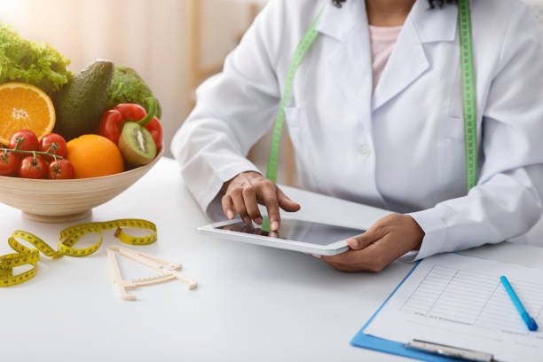 istock Black woman dietician working with digital tablet at clinic 1224772790