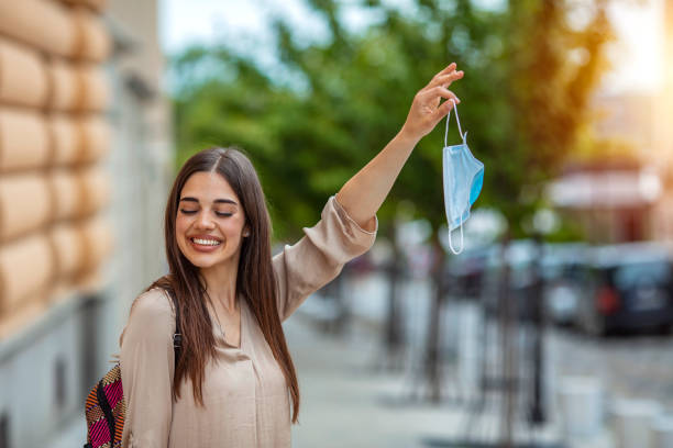 istock Young beautiful woman taking her mask off 1224773059