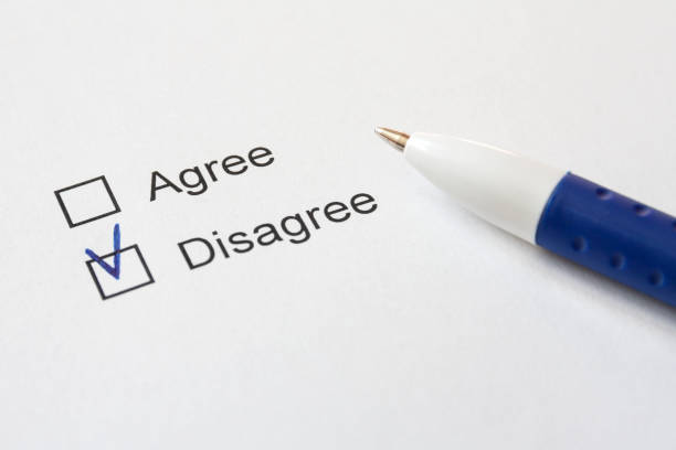 istock A white paper with choices (Agree, Disagree) and a blue pen. Selective focus. 1224773170