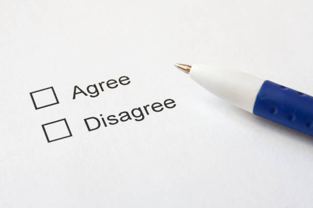 istock A white paper with choices (Agree, Disagree) and a blue pen. Selective focus. 1224773214