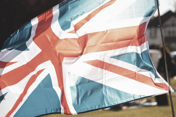 Union Jack flag flying in front of VE Day celebrations at a social distance street party in May 2020 Union Jack flag flying in front of VE Day celebrations at a social distance street party in May 2020 ve day celebrations uk stock pictures, royalty-free photos & images