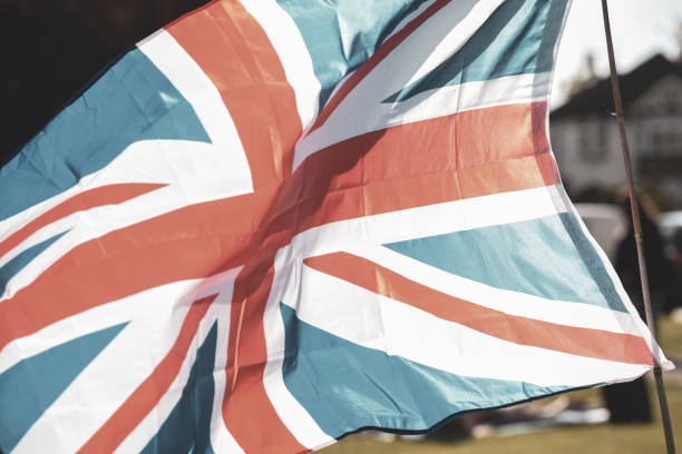 Union Jack flag flying in front of VE Day celebrations at a social distance street party in May 2020 Union Jack flag flying in front of VE Day celebrations at a social distance street party in May 2020 ve day celebrations uk stock pictures, royalty-free photos & images