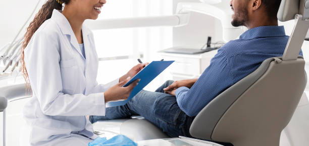istock Cropped of african stomatologist having conversation with patient 1224774759