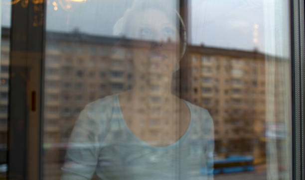 istock Young woman washing a window 1224775789