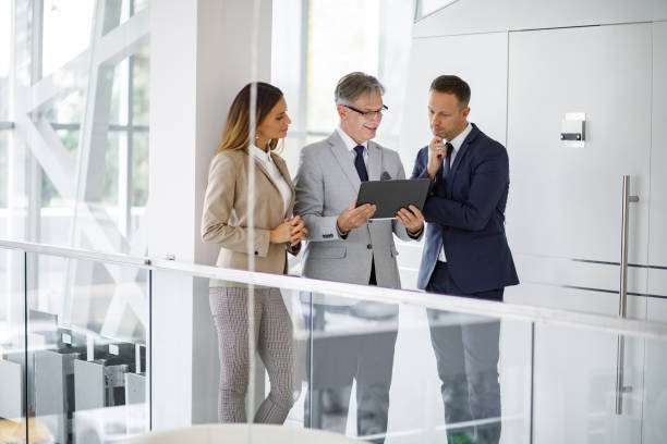 istock Group of mixed aged business people collaborating over digital tablet 1224776082