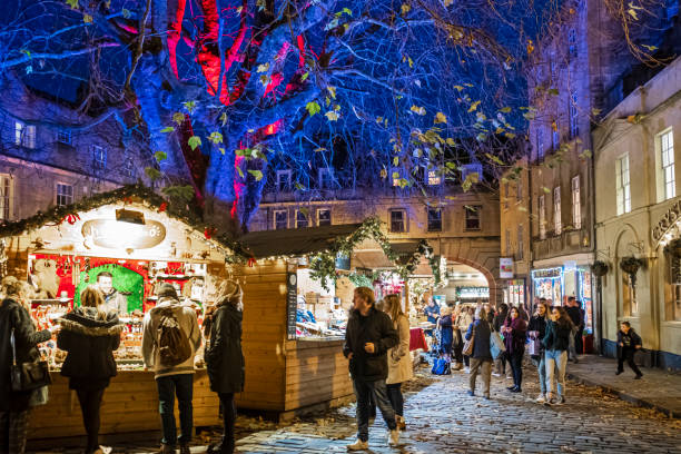 Christmas in Abbey Green, Bath (England, UK) People at the Christmas market set up in Abbey Green, in the old town of Bath. bath england stock pictures, royalty-free photos & images