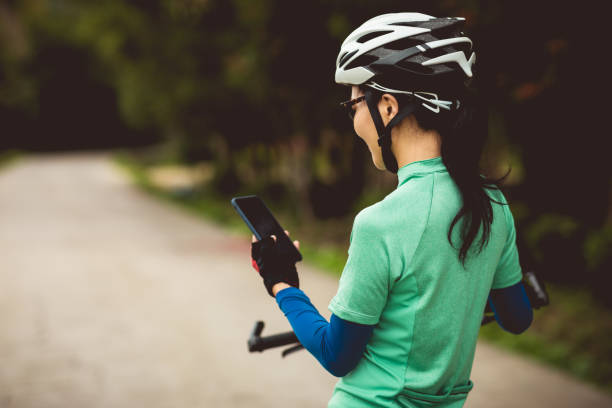 istock Cyclist use smartphone for navigation when riding mountain bike on forest trail 1224778234