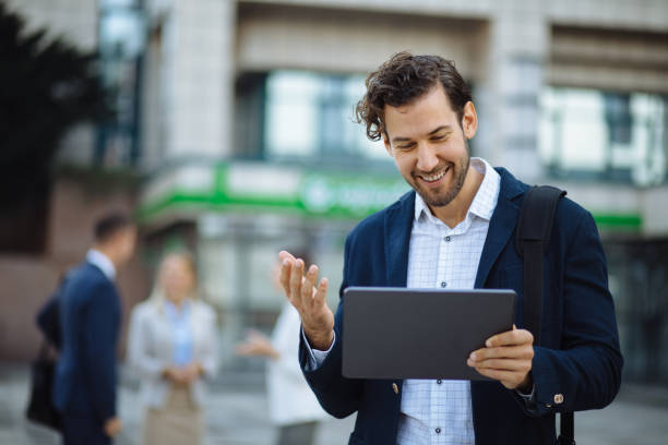 istock Young businessman using digital tablet outdoors 1224778780