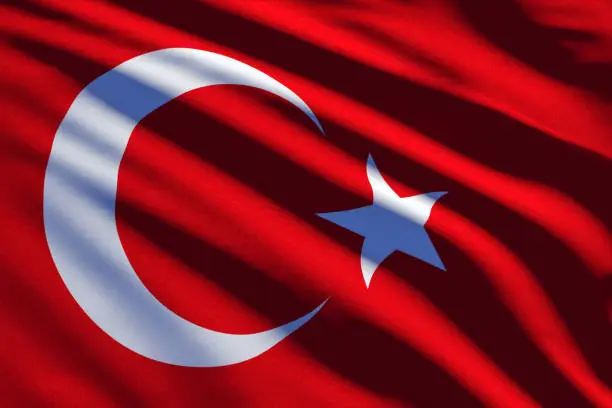 Close up shot of Turkish flag which is on a red color, crescent and star with white color.