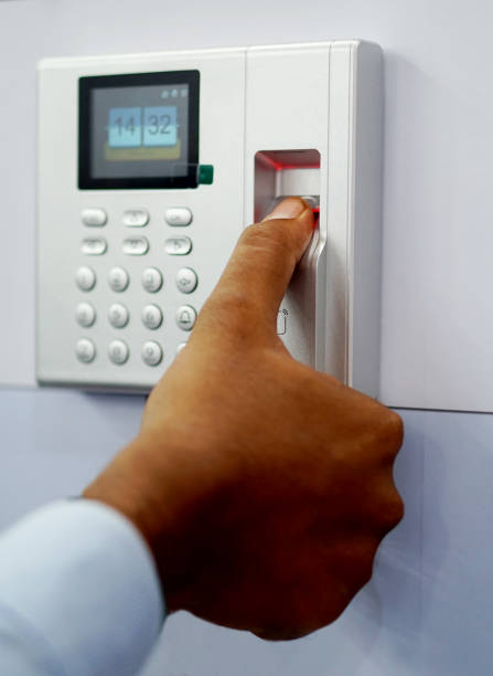 View of man touching finger print reader attendance and accessibility equipment man touching finger print reader attendance and accessibility security equipment Access Control Device stock pictures, royalty-free photos & images