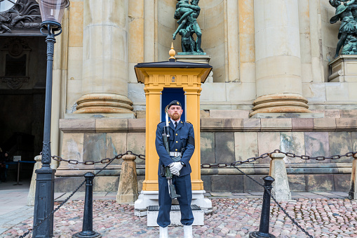 Royal Guard holding a gun on his hand in the gate of Stockholm Palace or the Royal Palace, the official residence and major royal palace of the Swedish monarch