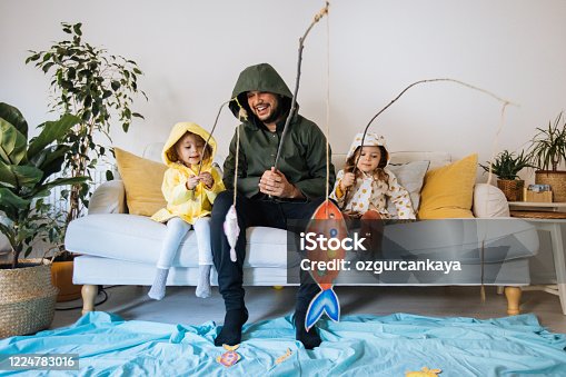 istock Kids with father playing fishing at home 1224783016