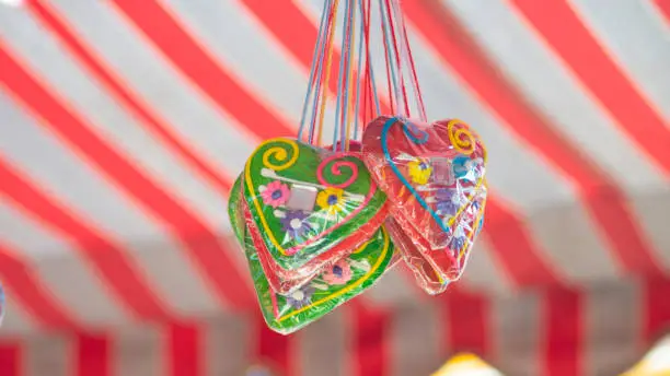Licitars hearts. Gingerbread hearts hanging below the festivals red-and-white striped tent.
