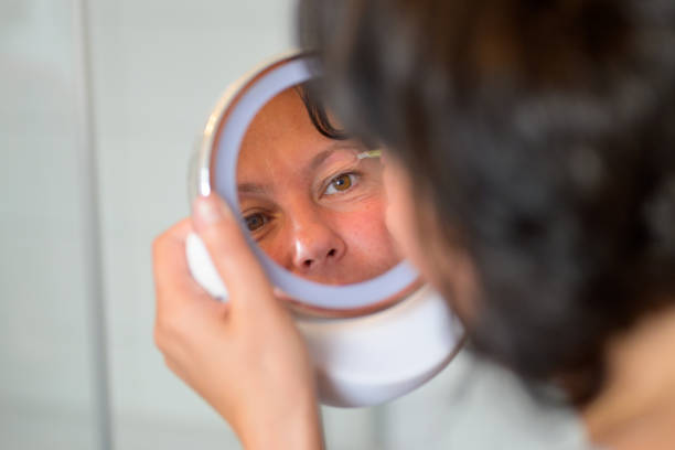 istock Woman plucking her eyebrows with tweezers 1224785669