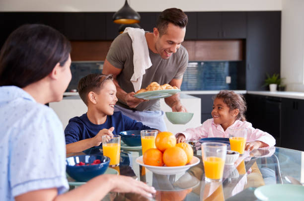 istock Hispanic Family Sitting Around Table Eating Breakfast Together 1224786772