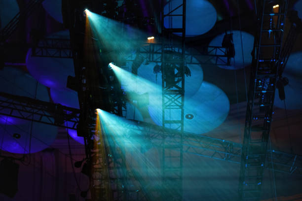 istock Blue reflector lights shining through smoke on theatre roof before performance 1224787590