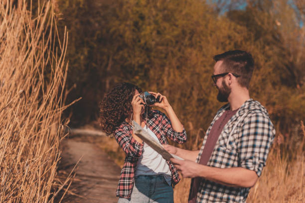 istock Couple taking photos while hiking 1224787871