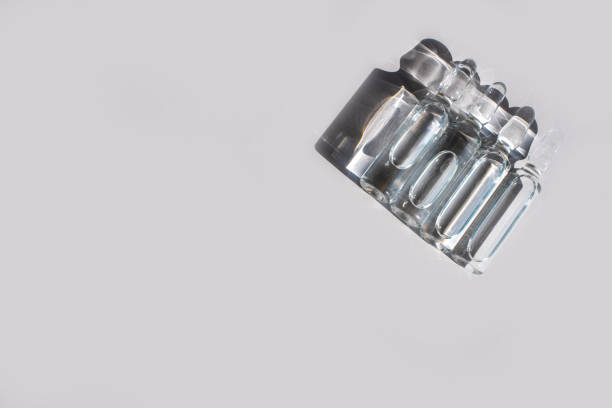 istock Ampuls with anti-virus vaccine with transparent liquid on white background. Copy space. Space for text 1224789941