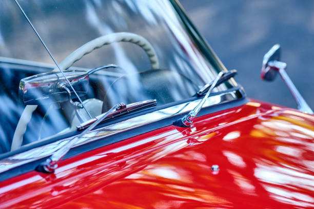 Closeup of details of beautiful red vintage car Closeup of details of beautiful red vintage car with the windscreen, the wipers and the bonnet. Seen in Germany in September. good condition stock pictures, royalty-free photos & images