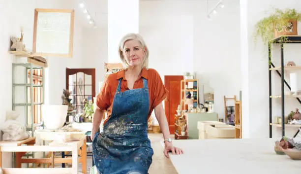 Shot of a confident mature woman working in a pottery studio