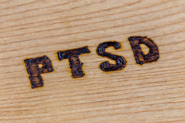 istock an abbreviation PTSD - post traumatic stress disorder - burned by hand on flat wooden board in diagonal composition 1224791258