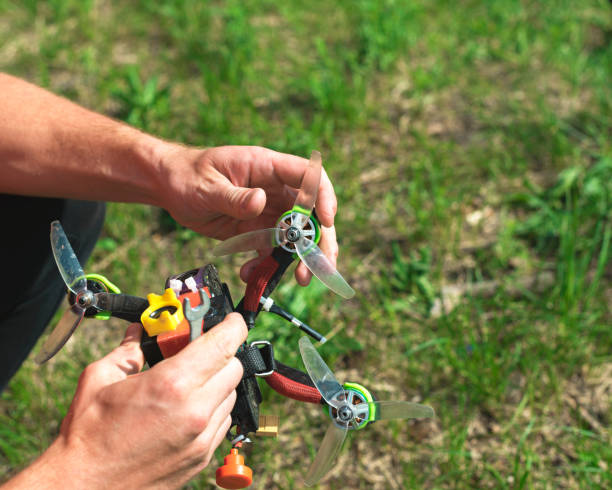 istock man repairs and adjusts a racing drone 1224792164