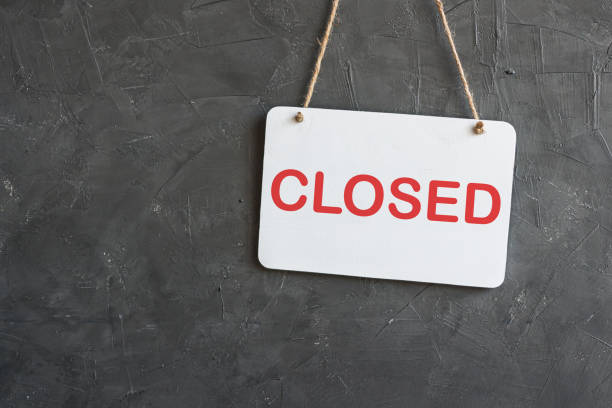 istock Sorry we're closed sign. White sign in back wall 1224793209