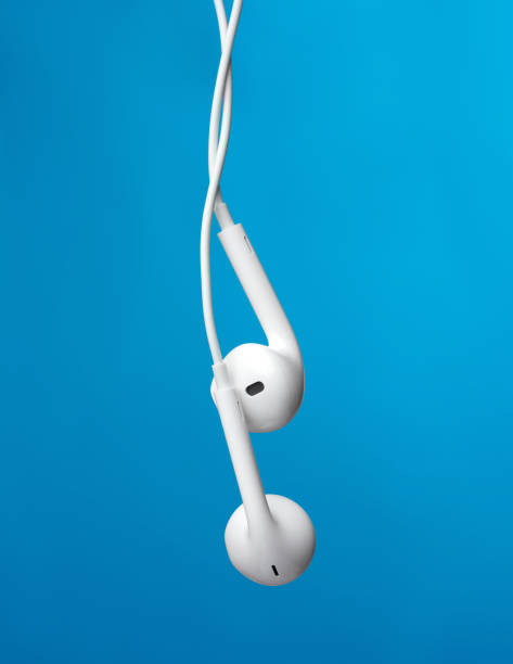 hanging headphones on a white cable, a modern gadget on a blue background