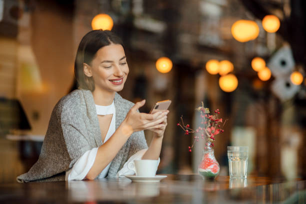 istock Beautiful young woman relaxing in a cafe 1224794673