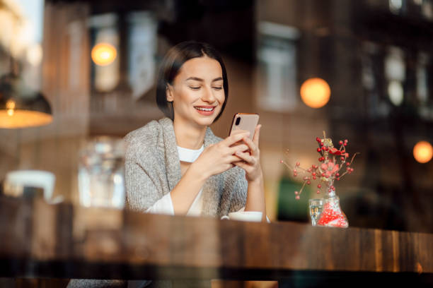 istock Beautiful young woman relaxing in a cafe 1224794680