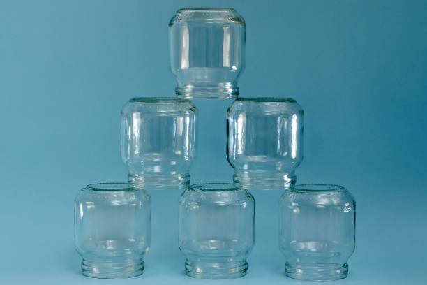 istock Pyramid of six transparent jars on a blue background. 1224794924