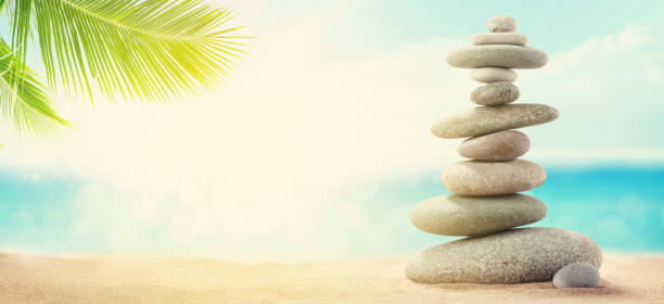 istock Pyramid of sea pebbles on a sunny sand beach 1224795949